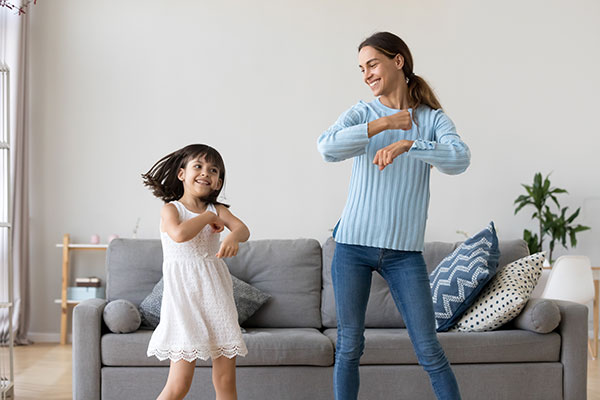 Mother and a daughter dancing together