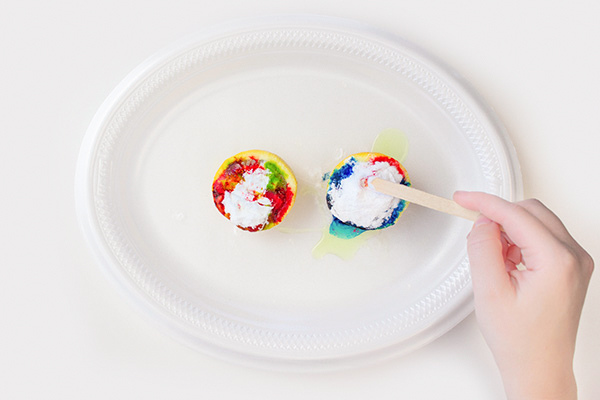 Baking soda on dishwashing liquid on food coloring on lemon