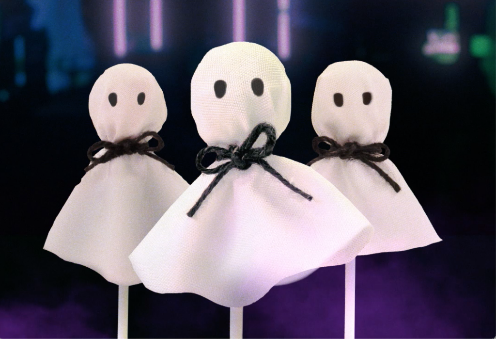 Three lollipops made to look like little ghosts with 2 black eyes and a little black ribbon.