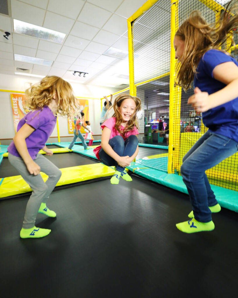 kids jumping on trampoline inside chuck e. cheese